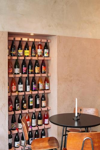 a wall filled with lots of bottles of wine at Burgstraat 8 in Ghent