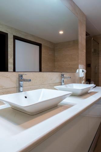 two sinks on a counter in a bathroom at Spectrum Resort, Spa & Residences in Udaipur