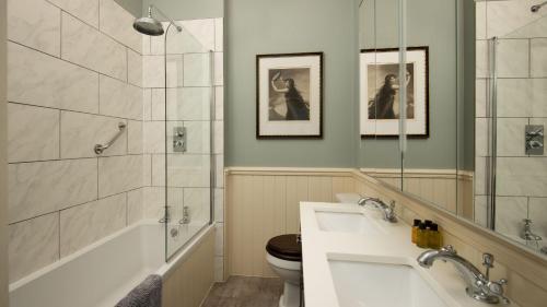 a bathroom with a sink and a shower and a toilet at East House in Berwick-Upon-Tweed