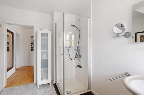 a glass shower in a bathroom with a sink at Schöne Dachgeschoss Wohnung in Warstein