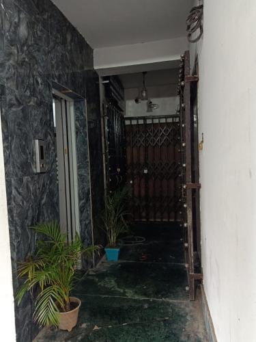 a hallway with potted plants in a house at Hotel Sana a family-friendly guest house in Kolkata