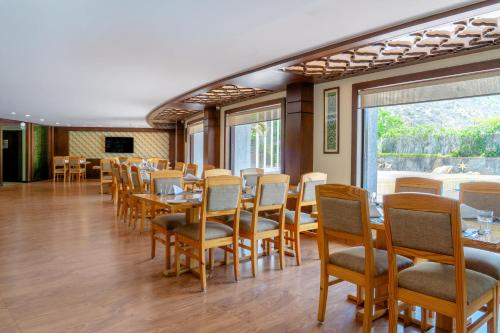 a dining room with wooden tables and chairs at Spectrum Resort, Spa & Residences in Udaipur