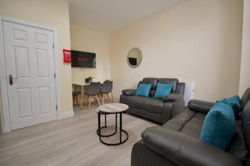 a living room with a couch and a table at Warwick Row Apartments Coventry City Centre - Flat 1 in Coventry
