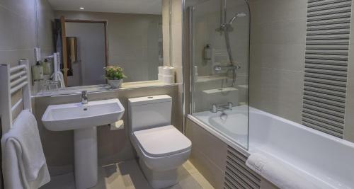 a bathroom with a toilet and a sink and a shower at Best Western The Hilcroft Hotel West Lothian in Whitburn