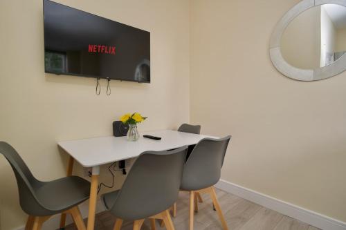 a dining room with a white table and chairs at Warwick Row Apartments Coventry City Centre - Flat 1 in Coventry
