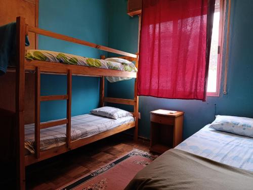 a bedroom with two bunk beds and a window at Patio Urbano Suites & beds in Montevideo