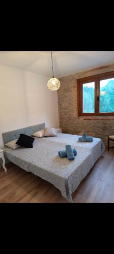 a bedroom with a large bed with two towels on it at Rural apartment La Cantonada in Guardiola de Berguedà