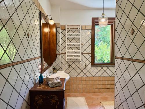 a bathroom with a sink and a mirror at La Segreta in Marina di Casalvelino