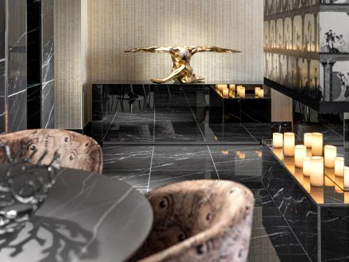 a dining room with a table and two chairs at Mamaison Hotel Chain Bridge Budapest in Budapest