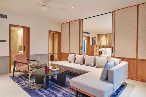 a living room with a couch and a table at The Dukes Retreat Khandala in Lonavala