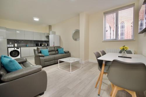 a living room with a couch and a table at Warwick Row Apartments Coventry City Centre - Flat 2 in Coventry
