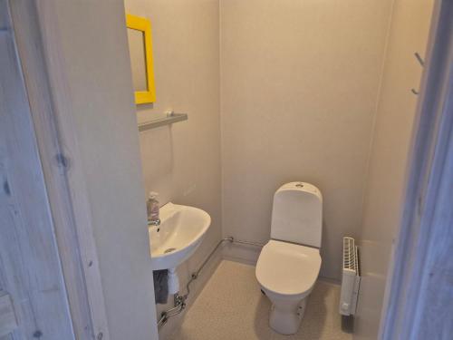 a small bathroom with a toilet and a sink at Prästgården i Funäsdalen in Funäsdalen