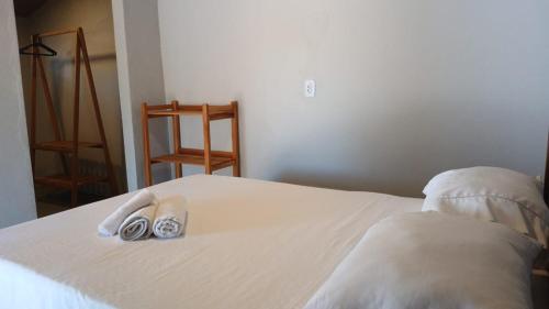 a bed with two pairs of shoes sitting on it at Suite Lua - Quarto e Banheiro com Ar Condicionado no Macapa Paradise in Luis Correia