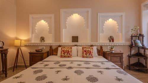 a bedroom with a bed and two windows at The Castle View Homestay in Būndi