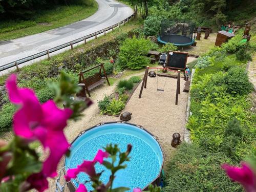 an overhead view of a garden with a blue pool at Hotýlek pod smrkem in Harrachov