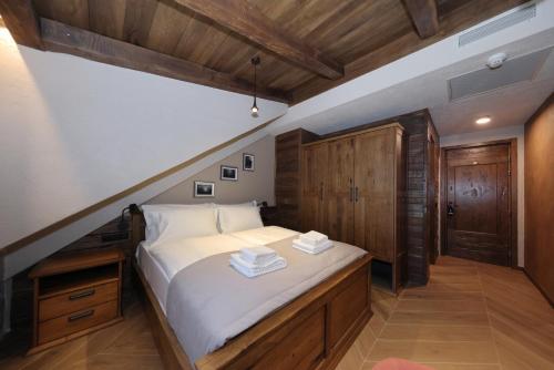 a bedroom with a large bed with wooden cabinets at Planinarski dom Vošac in Makarska