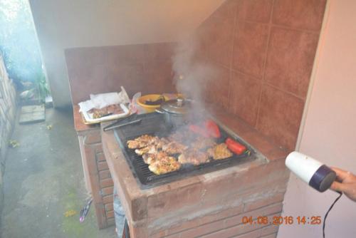 a grill with meat and other food on it at Villa Beba in Dobra Voda