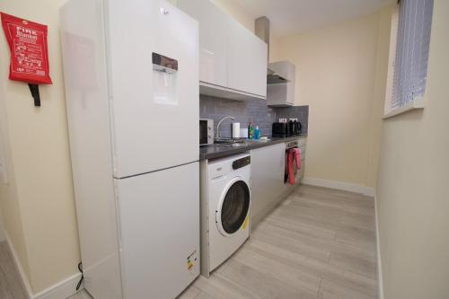 a kitchen with a washer and dryer in a room at Warwick Row Apartments Coventry City Centre - Flat 3 in Coventry