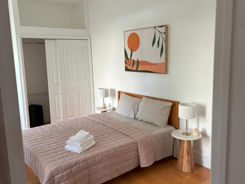 a bedroom with a bed with a pink blanket at Sunny Private Room in Bed-Stuy in Brooklyn