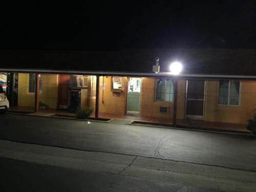 a building with a light on top of it at night at Hacienda Motel in San Jacinto
