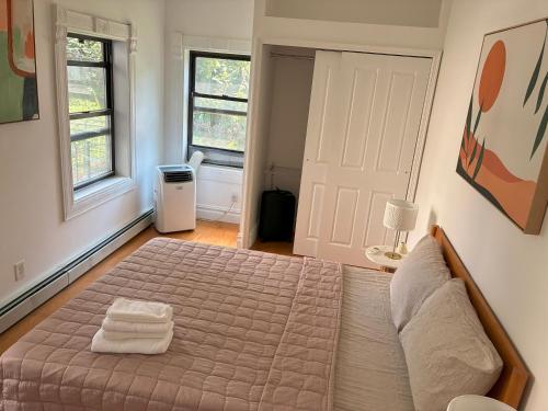 a bedroom with a bed with two towels on it at Sunny Private Room in Bed-Stuy in Brooklyn