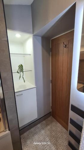 a room with a door and a plant on a shelf at Quakers Field View in Pennington