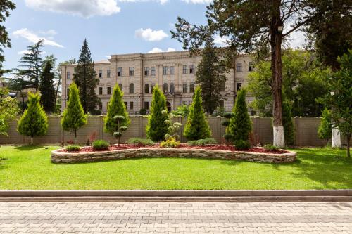 a garden in front of a building at Gelati Residence in Kutaisi