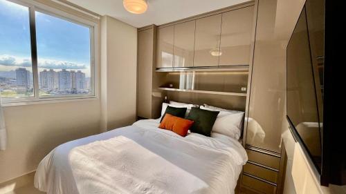 a bedroom with a large bed with a window at PRAIA Mar Sofisticado Novo in Vila Velha