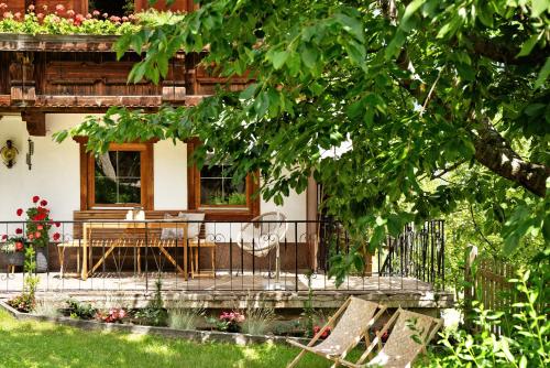 a house with a table and chairs in front of it at Berghaus Glosaleite Zillertal in Zellberg