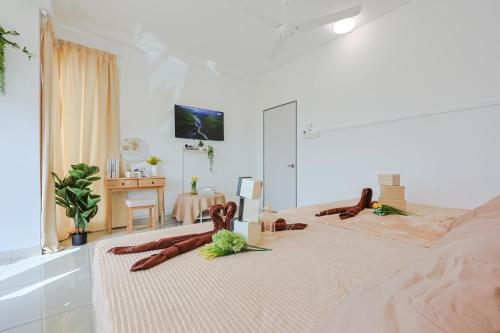 a bedroom with two people laying on a bed at Cozy Homestay #IOI City Mall #Putrajaya #17 Pax in Puchong