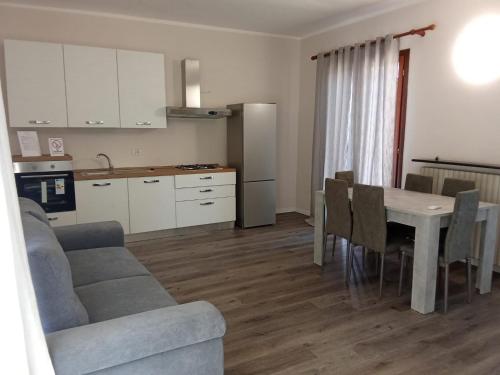 a kitchen and living room with a table and a couch at Hotel Edelweiss Mantova in Castel dʼArio