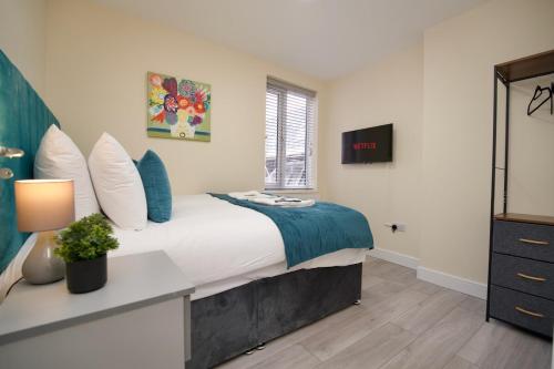 a bedroom with a bed with a desk and a window at Warwick Row Apartments Coventry City Centre - Flat 4 in Coventry