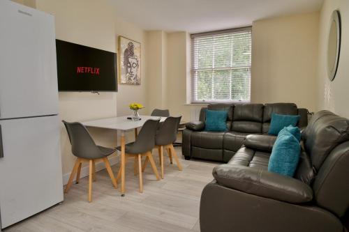 a living room with a couch and a table at Warwick Row Apartments Coventry City Centre - Flat 4 in Coventry