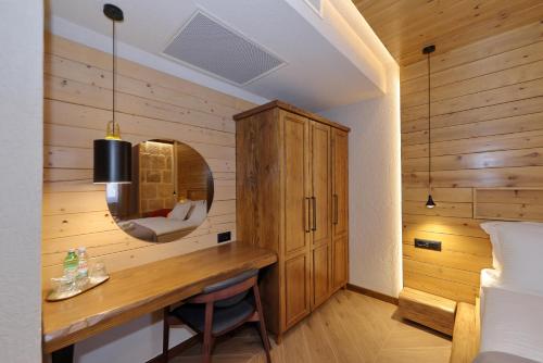 a bedroom with a desk and a mirror and a bed at Planinarski dom Vošac in Makarska