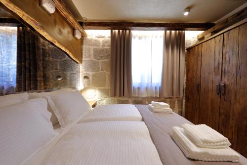 a bedroom with a bed with two towels on it at Planinarski dom Vošac in Makarska