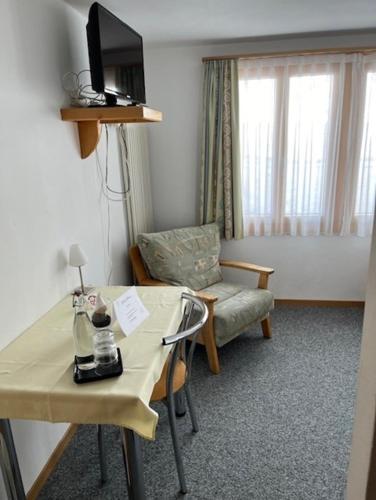 a hotel room with a table and a chair at Hotel Aletsch in Bettmeralp