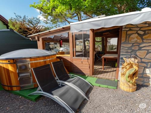 a cabin with a deck with a table and chairs at Privát Prima in Liptovský Ján