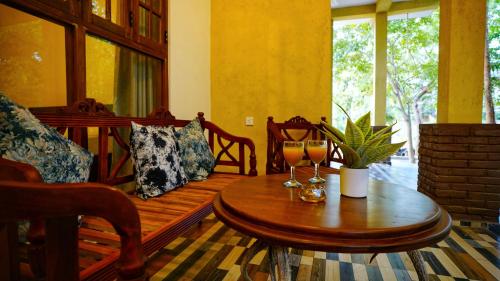 a living room with a wooden bench and a table at The Nature Resort in Dambulla