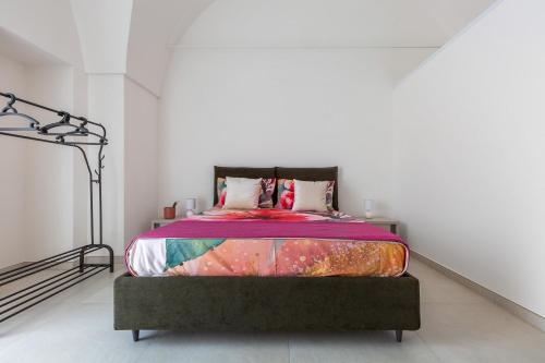 a bedroom with a bed in a white room at Amate' by BarbarHouse in Ruffano