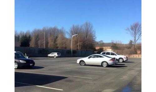 a group of cars parked in a parking lot at Capitol Inn by Belvilla Richmond Airport VA in Sandston