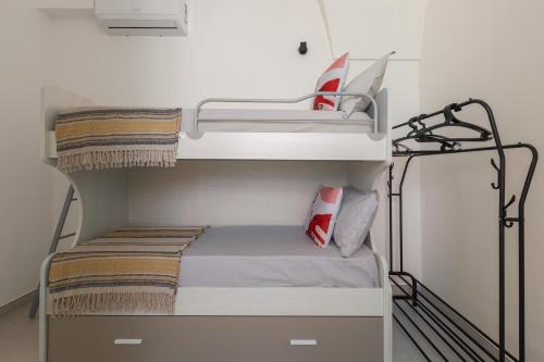 a room with two bunk beds and a laptop on it at Amate' by BarbarHouse in Ruffano