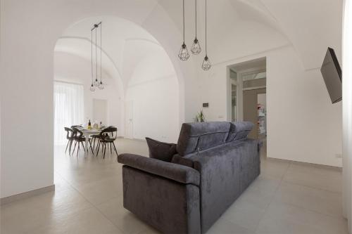 a living room with a couch and a table at Amate' by BarbarHouse in Ruffano
