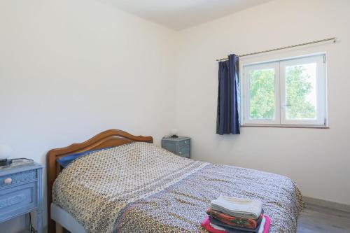 a bedroom with a bed and a window at Glycine in Paimpol