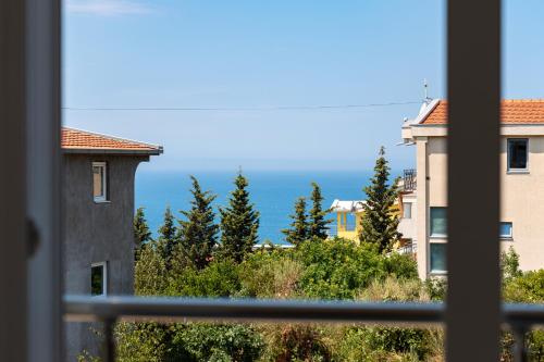 a view of the ocean from a window at OliveRock Apartments - Hladna Uvala in Kruče