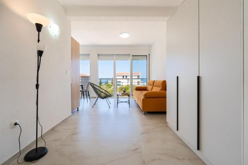 a living room with a couch and a table at OliveRock Apartments - Hladna Uvala in Kruče