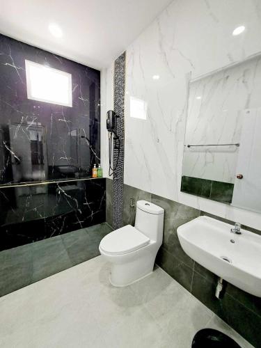 a bathroom with a white toilet and a sink at The pool villa privacy chomdao khonkaen in Khon Kaen