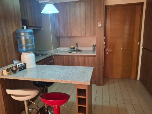 a kitchen with a counter with a drink pitcher on it at Condominio en el Centro de Calama in Calama