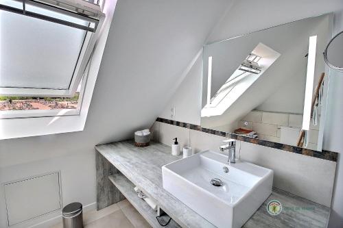 a bathroom with a sink and two skylights at Ty spot in Trégastel