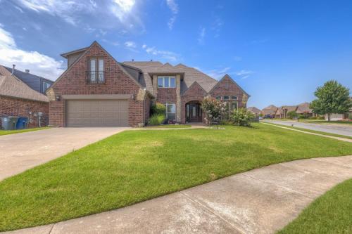 a large brick house with a driveway at Unforgettable Memories Easy Living in Broken Arrow
