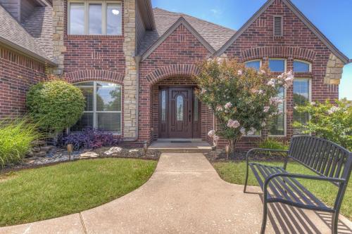 a house with a bench in front of it at Unforgettable Memories Easy Living in Broken Arrow